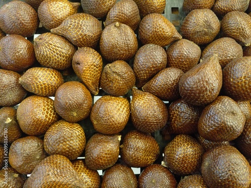 Stacked fresh tropical Salak fruits, revealing their distinctive scaly texture, a delicious exotic food