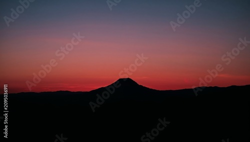 Sunset Over Mountain Range in the Evening Sky With Purple and Orange Colors