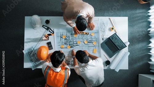 Foto Top down aerial view of smart architect engineer team pointing and discussing about building construction