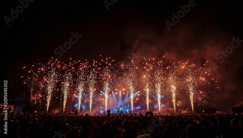 Fireworks Light up the Stage During a Concert While Crowd Enjoys the Music in...