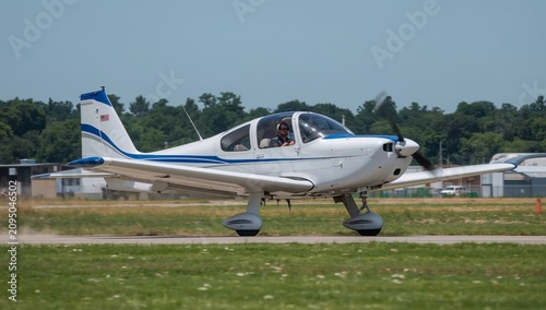 Pilot Operates Small Aircraft on Runway Near Airport on Sunny Day