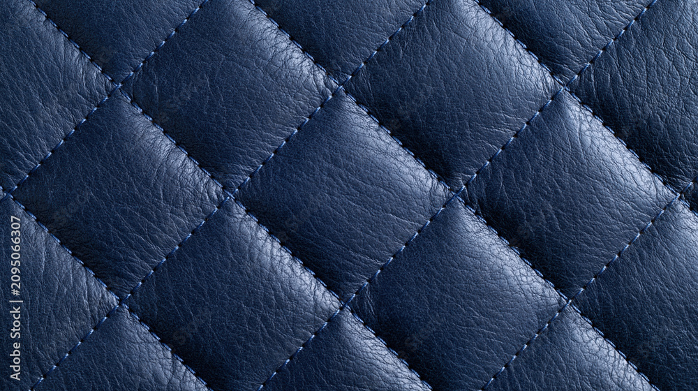 Obraz premium Blue quilted leather texture with stitched diamond pattern