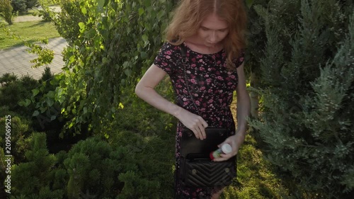 Elegant Woman in Floral Lace Gown Strolling Through Lush Garden Pathway: Graceful Wear Shoot in Natural Light