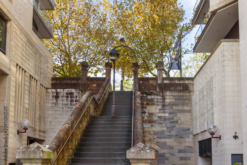 Deserted old staircase between aparment buildings in a city centre on a sunny autumn day