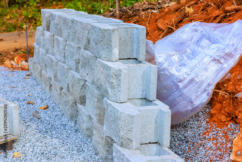 Construction site stacked concrete blocks during assemble retaining wall