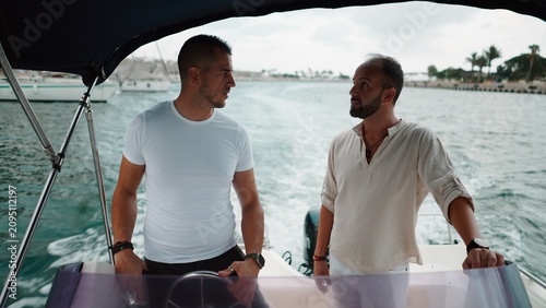 Εκτύπωση καμβά Two men chatting on a boat during a summer ocean outing