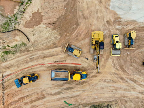 Aerial Top Down View of Heavy Construction Machinery Fleet on Dirt Site