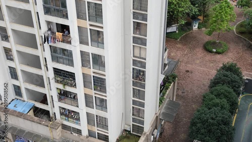 Aerial view of a high-rise residential apartment block with balconies and laundry hanging in Liuzhou, Guangxi, China. Chinese urban housing, high-density living, and everyday residential life