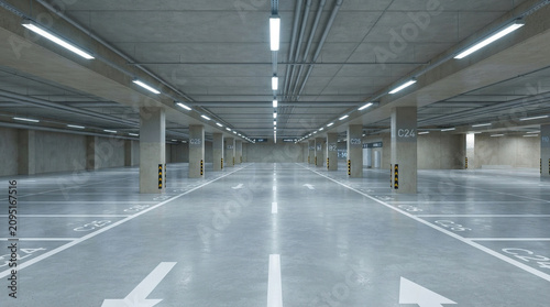 Empty underground parking garage with concrete columns and bright lights