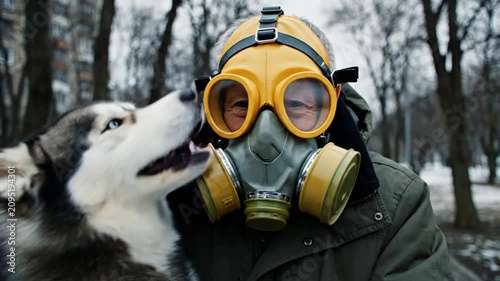 Man Wearing Gas Mask Holding Siberian Husky Dog in Winter Park | Dystopian Concept