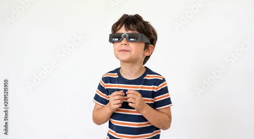 Young boy wearing eclipse glasses looking up with excitement