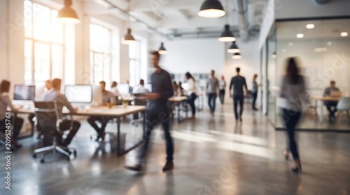 Blurred motion of diverse business people walking through contemporary open office space with employees working at desks in background during busy workday in urban corporate headquarters