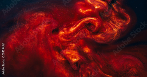 Sparkling ink blend. Dust fluid. Shimmering metallic particles paint copper red smoke flow. Mysterious color mix splash blur abstract black background.