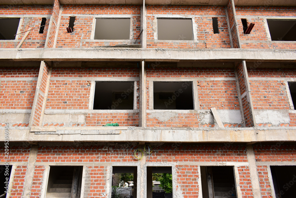 Obraz premium exterior view of brick house under construction with concrete structure