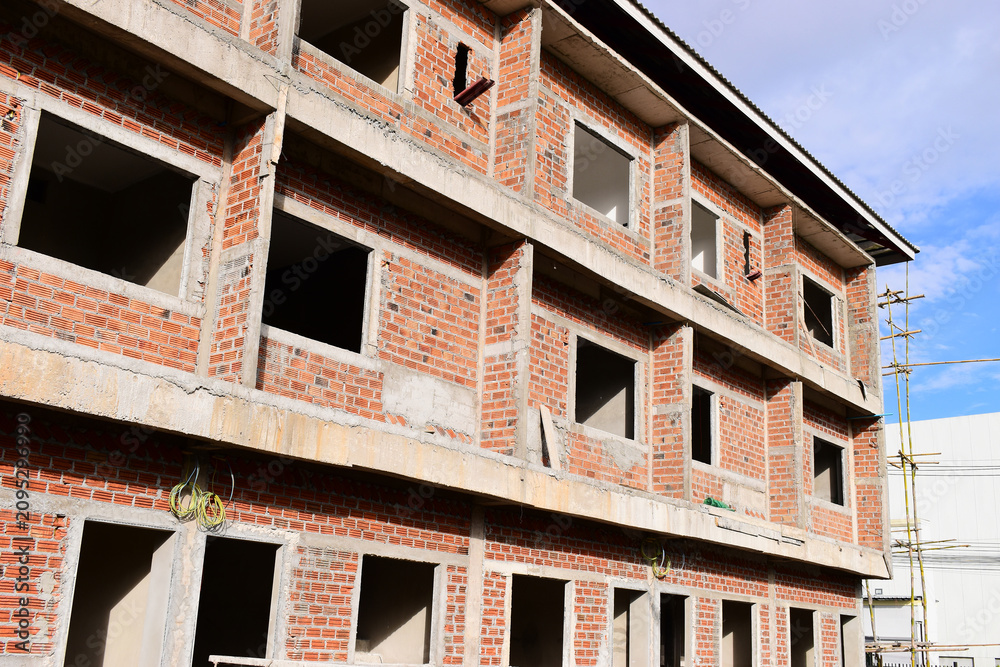 Obraz premium exterior view of brick house under construction with concrete structure