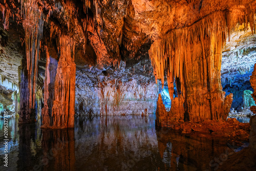 Cuadro en lienzo Illumined stalactites and crystal-clear subterranean lake inside Neptune's Grott