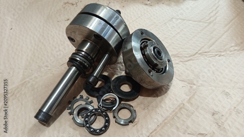 Tableau sur toile Disassembly of mechanical machine parts with ball bearing and shaft on a worksho