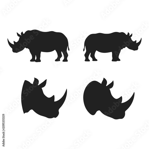 Photography Black silhouettes of rhinos in different poses and angles on white background ic