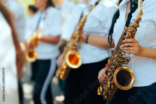 Canvas Print Female Saxophonists Playing Instruments Close Up In Marching Band