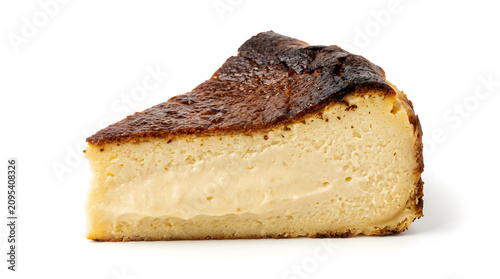 A rich slice of Basque burnt cheesecake with a perfectly caramelized top and creamy center, isolated on white background