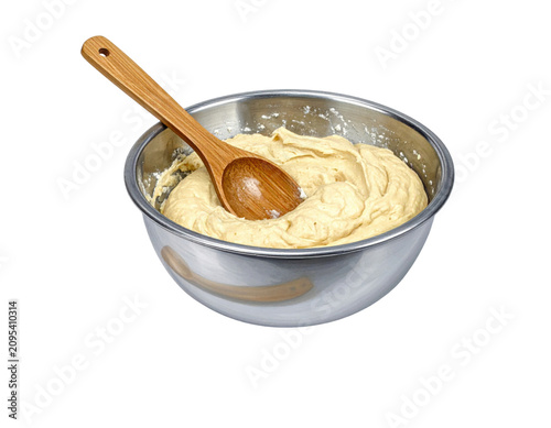 Cake batter mixed in steel bowl with wooden spoon