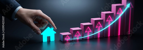 Hand placing a house icon on a rising bar chart. Real estate growth and property market investment.