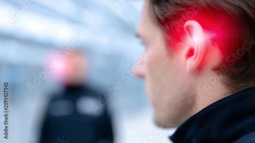 Discover an intriguing close-up scene featuring a man with a glowing ear. This footage embodies a high-tech essence and fits well in modern media. Make your project stand out. AI