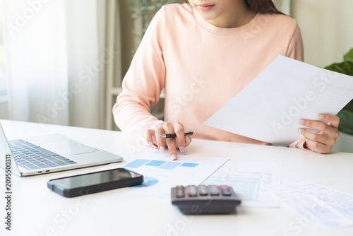 Obraz na plátně Deduction planning, debt asian young woman calculating money balance of finance from bill and income, cost budget expenses for pay money form personal individual on table at home