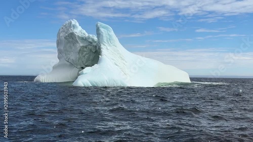 Large majestic iceberg floating in the ocean off coast of Newfoundland
