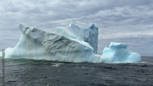 Majestic iceberg floating on a choppy ocean off coast of Newfoundland