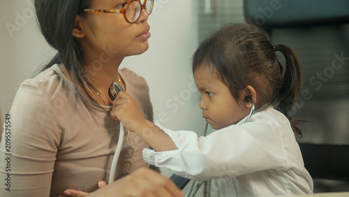 Photography Child Pretending to Be a Doctor During Family Role Play