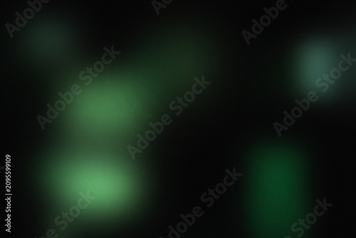 Foto Green bokeh lights on black background