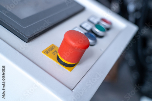 Fotografía Red emergency stop button activating on industrial machine control panel