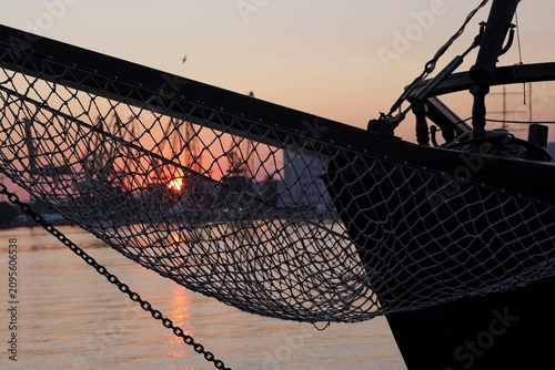 Fotografía Ship bowsprit netting with sunset reflecting on water