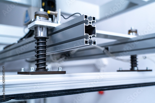 Bild auf Leinwand Aluminum extrusion profiles and springs on an industrial machine in a factory se