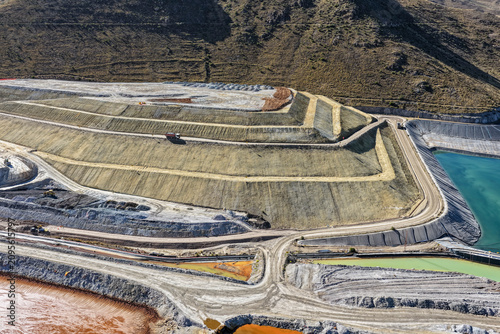 Aerial View of Heap Leach Pad with Turquoise Geomembrane Ponds in Arid Mountains