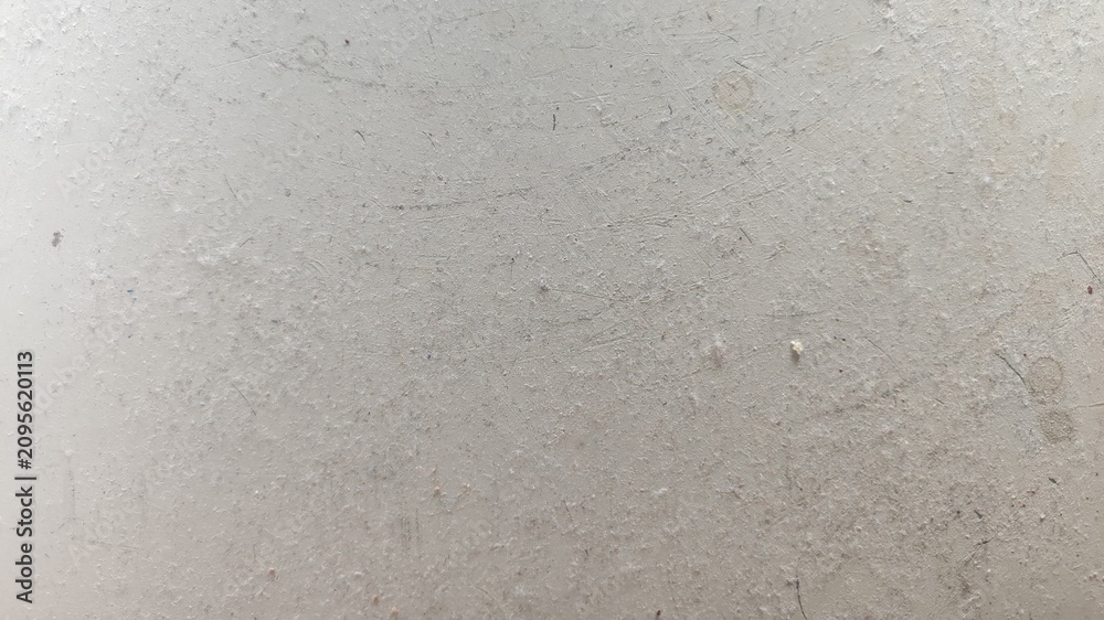 Fototapeta premium Dusty dirty plastic surface with scratches and damage grain background grayscale monochrome texture. Scratched plastic surface with dirt stains and dust flakes.
