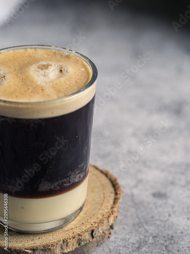 Close up of layered Spanish coffee with condensed milk and copy space