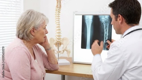 Skeletal disease explanation: osteoporosis diagnose, bone density, medical consult, patient concern, doctor inform, fragile structure, health problem, elder woman.