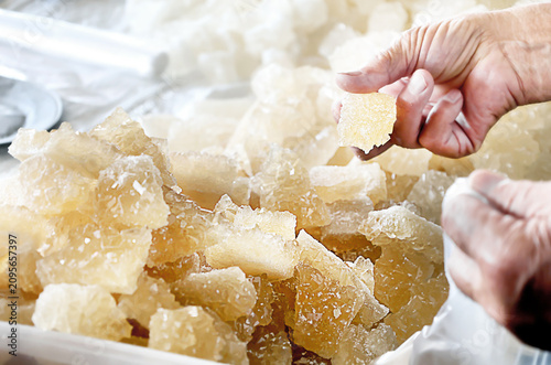 Fotografie Customer selecting natural navvat rock sugar at a traditional market