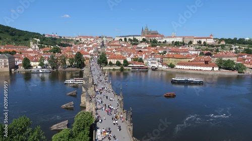 Picturesque city of Prague in Czechia (Czech Republic). Cityscape with view above the Charles Bridge, Prague Castle on a hill and cruise boats on Vltava River.