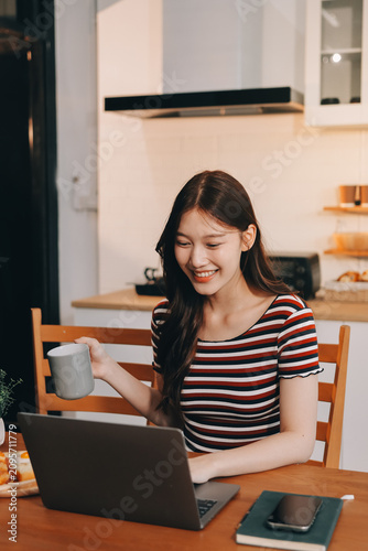 Asian woman using computer remote for business studying, watching online virtual webinar training meeting, video call. asian business woman talking on laptop in home office. Banner, copy space