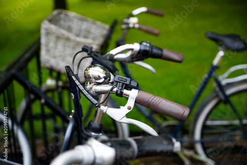 A row of bicycles parked at a designated bicycle parking area in the Netherlands. The scene reflects Dutch cycling culture, everyday urban transportation and the importance of bicycles in city life.