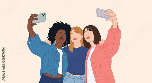 Group of three diverse young women smiling happily and taking a selfie together with their smartphones.