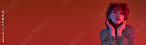 Photography Captivating young woman with vibrant red curls showcasing modern style against a