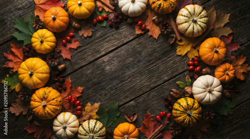 Happy halloween autumn harvest festive pumpkins leaves and berries on rustic wood background for fall decor