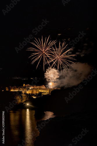 Fireworks illuminating the Bonifacio citadel over the sea at night