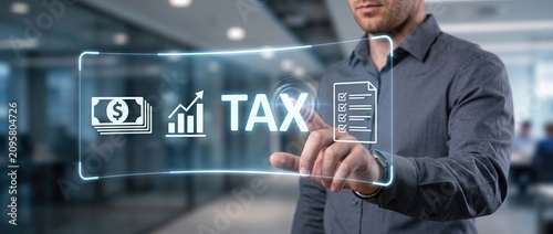 Professional man engaging with a digital tax platform highlighting financial data growth charts and tax documents in a contemporary office setting
