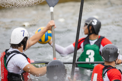 Canvastavla Canoe polo players in action, one athlete attempts to pass a ball while another