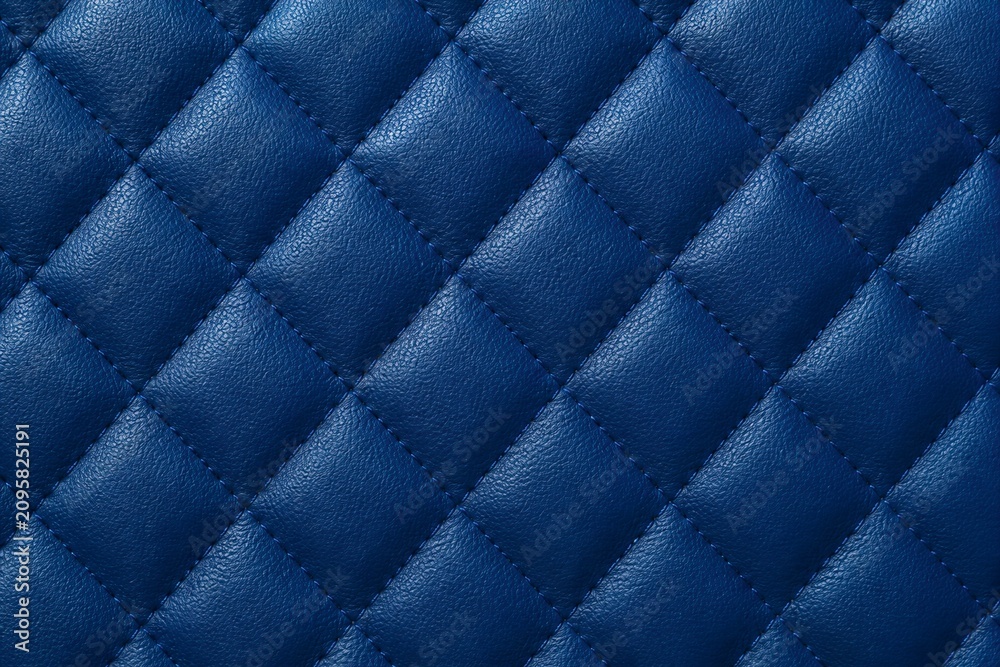 Obraz premium Quilted blue leather surface showing stitched diamond pattern